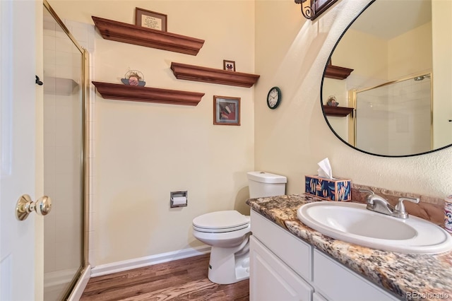 bathroom with toilet, an enclosed shower, vanity, and wood-type flooring