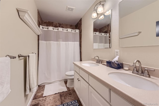 bathroom with toilet, curtained shower, and vanity