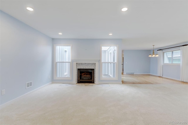 20 Scott Dr, Broomfield, CO 80020 - unfurnished living room featuring a chandelier, carpet flooring, a tile fireplace, baseboards, and recessed lighting