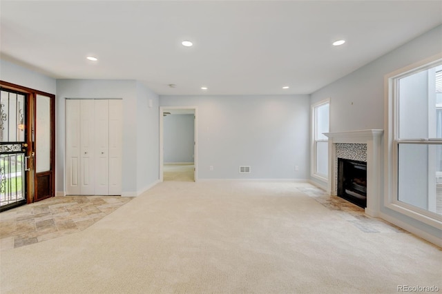 20 Scott Dr, Broomfield, CO 80020 - unfurnished living room featuring light carpet, recessed lighting, plenty of natural light, a tiled fireplace, and baseboards