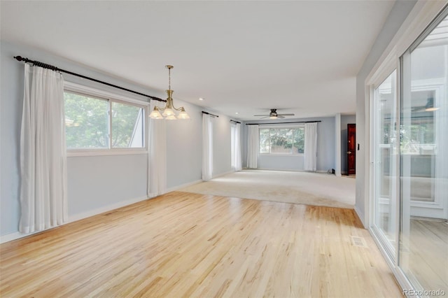 20 Scott Dr, Broomfield, CO 80020 - empty room with a chandelier, light wood-type flooring, baseboards, and ceiling fan