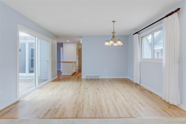 20 Scott Dr, Broomfield, CO 80020 - empty room with a chandelier, light wood-style floors, and baseboards