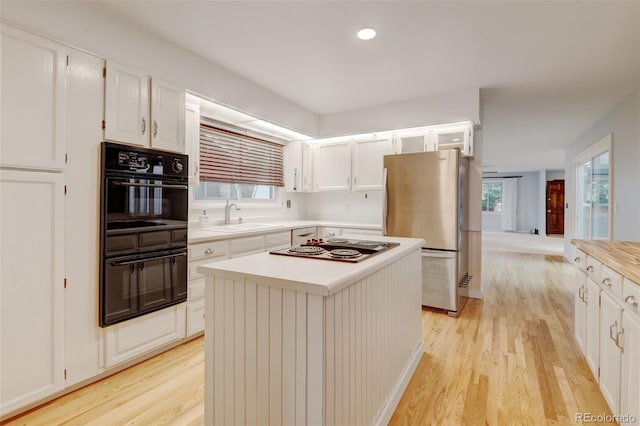 20 Scott Dr, Broomfield, CO 80020 - kitchen with freestanding refrigerator, a sink, light wood-style floors, white cabinetry, and recessed lighting