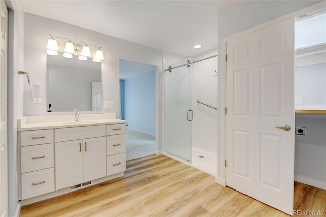 20 Scott Dr, Broomfield, CO 80020 - full bathroom with wood finished floors, a shower stall, and vanity
