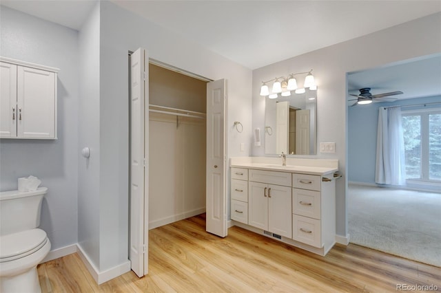 20 Scott Dr, Broomfield, CO 80020 - full bath featuring vanity, ceiling fan, baseboards, and wood finished floors