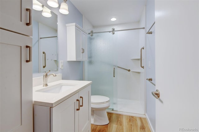 20 Scott Dr, Broomfield, CO 80020 - full bathroom with toilet, a stall shower, vanity, and wood finished floors