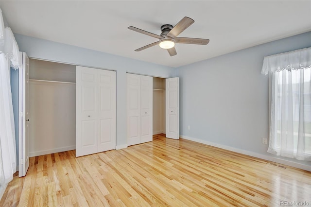 20 Scott Dr, Broomfield, CO 80020 - unfurnished bedroom featuring two closets, light wood-style floors, ceiling fan, and baseboards