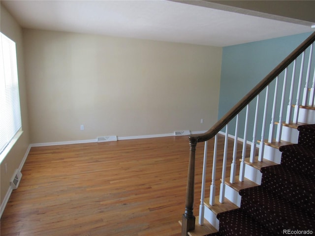 staircase with hardwood / wood-style flooring