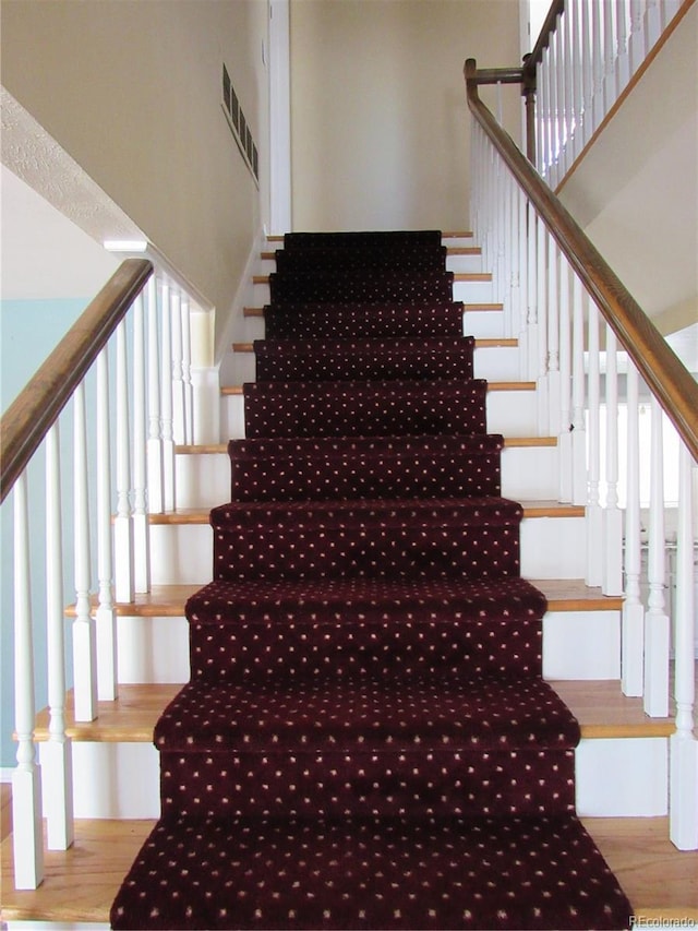 stairway with hardwood / wood-style floors