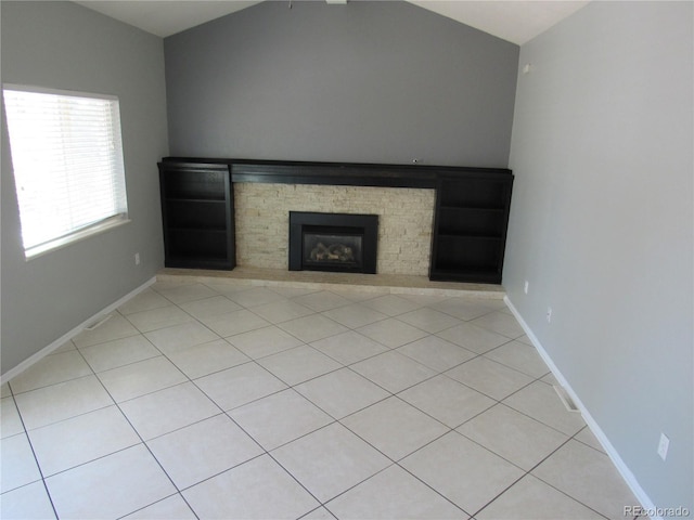 unfurnished living room featuring vaulted ceiling and a fireplace