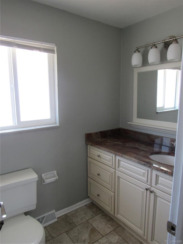 bathroom featuring toilet, tile patterned floors, and vanity