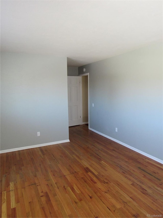 unfurnished room featuring dark wood-type flooring