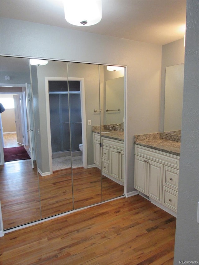 bathroom featuring hardwood / wood-style floors, vanity, and toilet