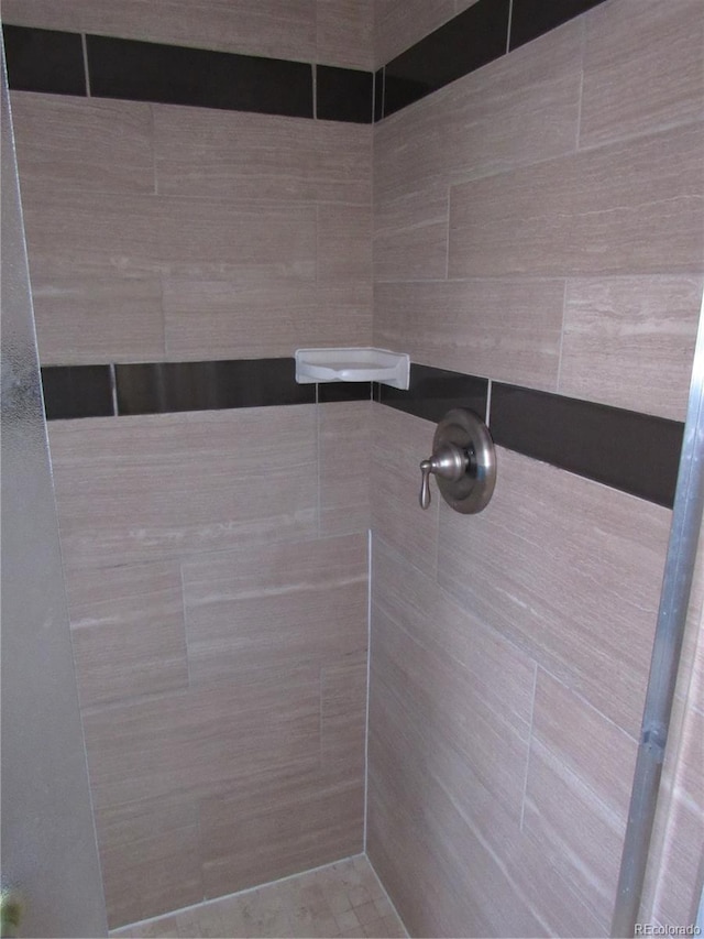 bathroom with tiled shower