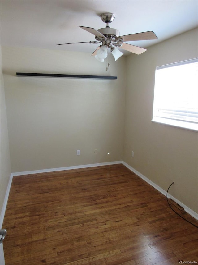 empty room with dark wood-type flooring and ceiling fan