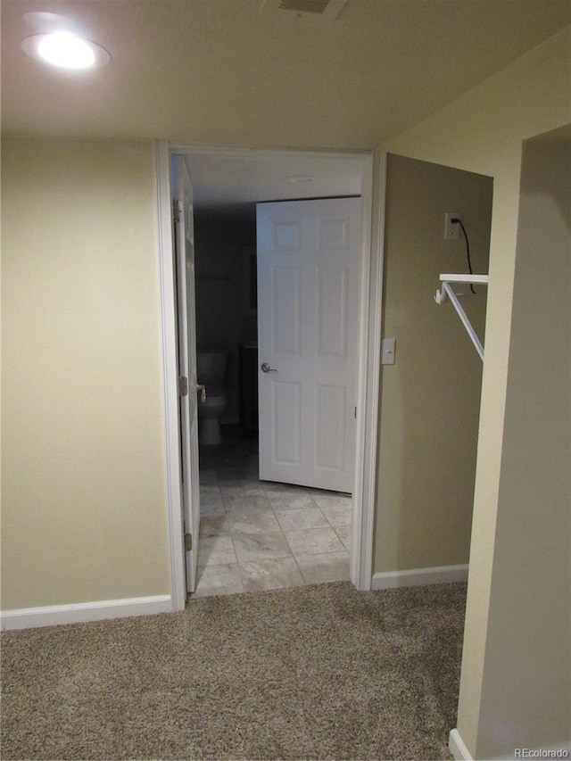 hallway with light colored carpet