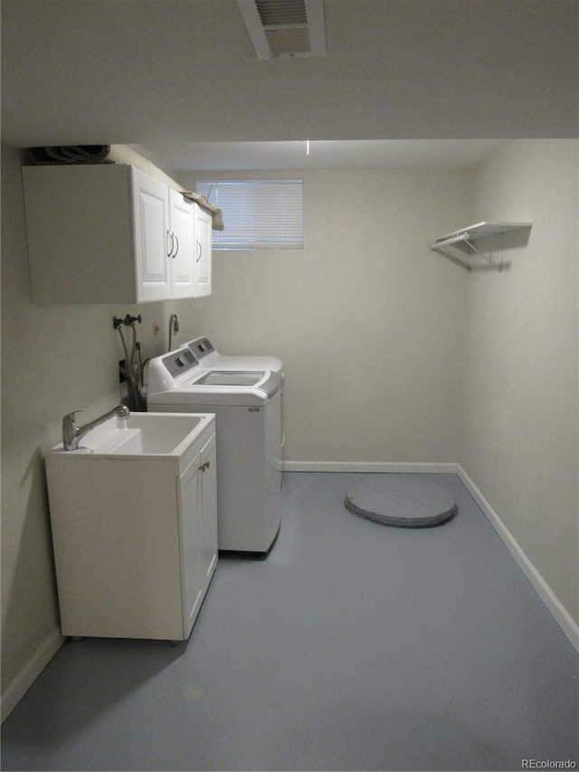 laundry area with cabinets, sink, and washing machine and clothes dryer