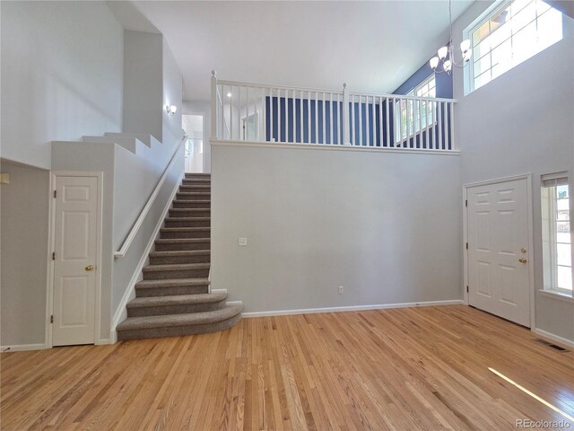 8772 S Carr Way, Littleton, CO 80128 - entrance foyer featuring a high ceiling, wood finished floors, stairway, and a chandelier