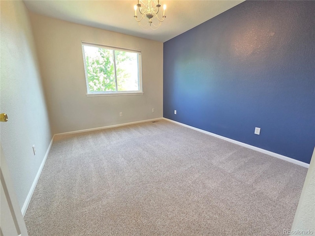 8772 S Carr Way, Littleton, CO 80128 - spare room with a chandelier, carpet, and baseboards