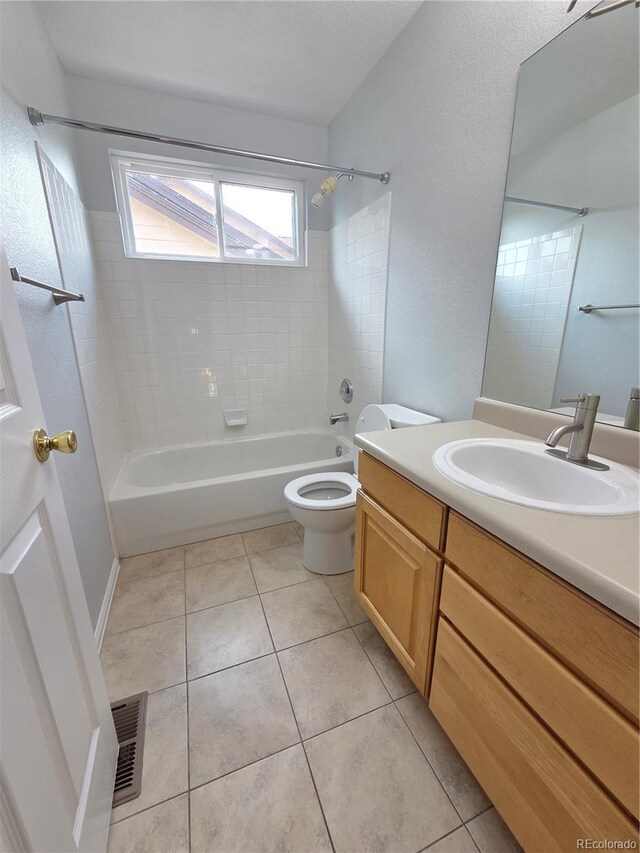 8772 S Carr Way, Littleton, CO 80128 - bathroom with washtub / shower combination, vanity, toilet, and tile patterned floors