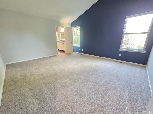 8772 S Carr Way, Littleton, CO 80128 - carpeted spare room with baseboards and lofted ceiling