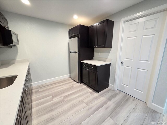 8772 S Carr Way, Littleton, CO 80128 - kitchen featuring black microwave, light countertops, baseboards, light wood-style flooring, and recessed lighting