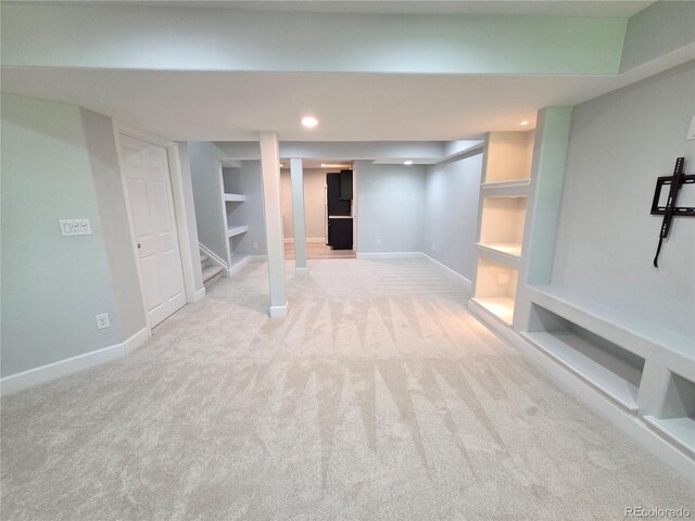 8772 S Carr Way, Littleton, CO 80128 - finished below grade area featuring carpet flooring, baseboards, recessed lighting, stairway, and built in shelves