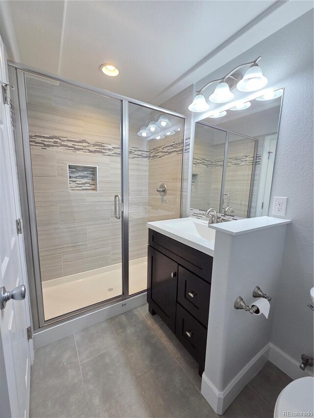8772 S Carr Way, Littleton, CO 80128 - full bathroom featuring toilet, tile patterned floors, a stall shower, vanity, and recessed lighting