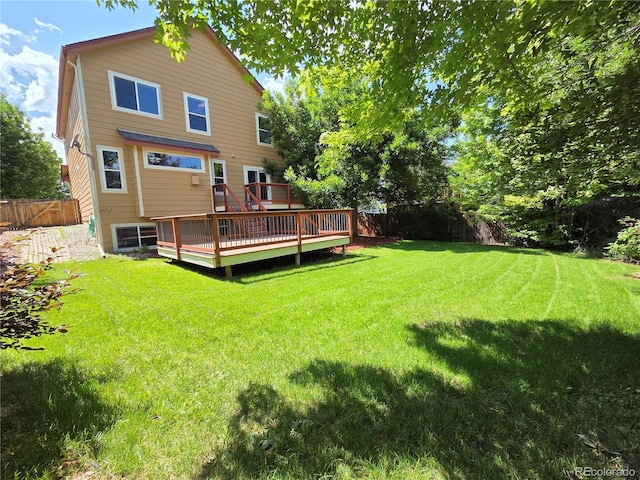 8772 S Carr Way, Littleton, CO 80128 - rear view of property with a fenced backyard and a wooden deck