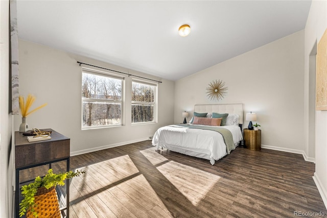 bedroom with dark hardwood / wood-style floors