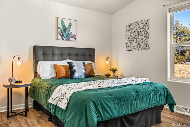 bedroom with hardwood / wood-style floors