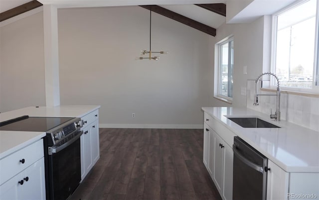 kitchen with white cabinets, decorative light fixtures, stainless steel appliances, sink, and lofted ceiling with beams