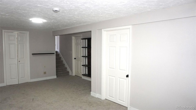 basement with light carpet and a textured ceiling