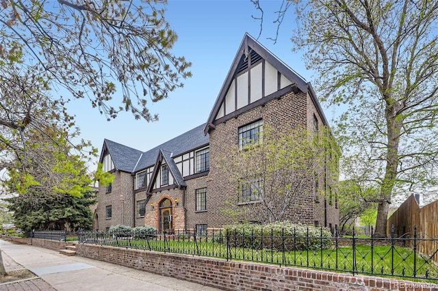 view of property exterior featuring a fenced front yard and brick siding