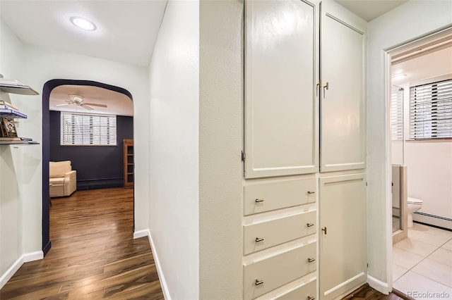 hall with baseboards and dark wood-style floors