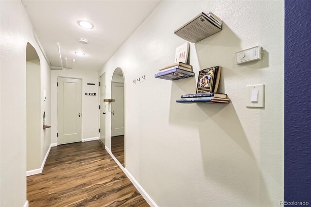 2233 Kearney St Unit 19, Denver, CO 80207 - corridor with arched walkways, baseboards, and wood finished floors