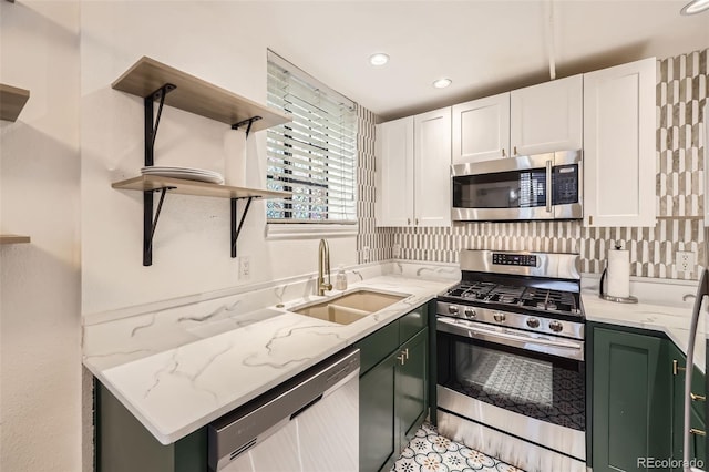 kitchen featuring open shelves, white cabinets, a sink, green cabinets, and stainless steel appliances
