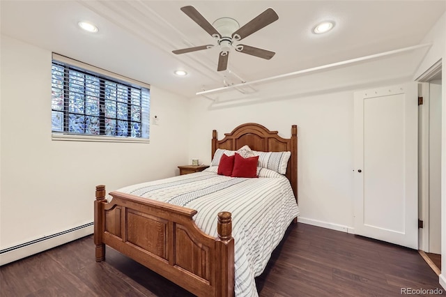 bedroom with a baseboard heating unit, recessed lighting, and wood finished floors