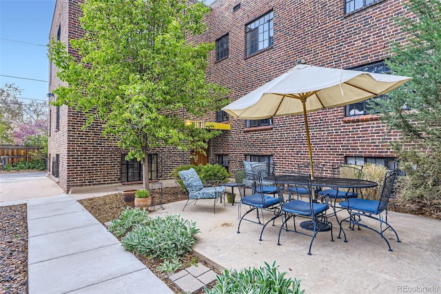 view of patio / terrace with outdoor dining area and fence