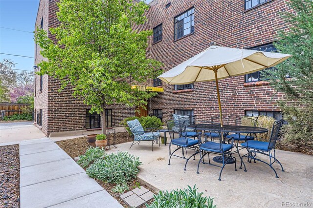 2233 Kearney St Unit 19, Denver, CO 80207 - view of patio / terrace with outdoor dining area and fence