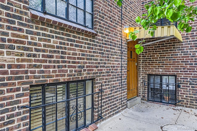 property entrance featuring brick siding