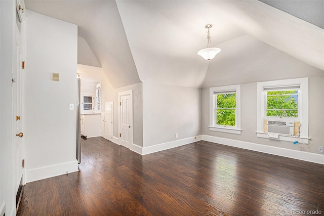 unfurnished living room featuring cooling unit, dark hardwood / wood-style flooring, and vaulted ceiling