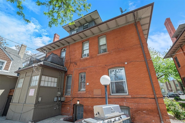 rear view of property featuring a balcony