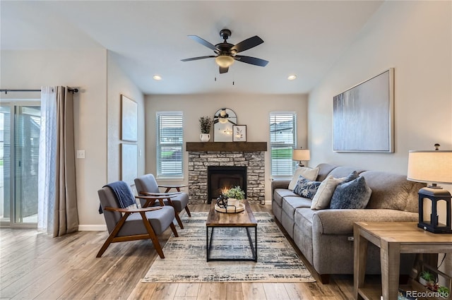 4318 Hessite Loop, Colorado Springs, CO 80938 - living room with healthy amount of natural light, ceiling fan, light wood-type flooring, a stone fireplace, and recessed lighting