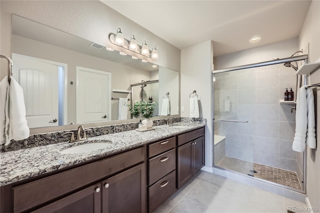 4318 Hessite Loop, Colorado Springs, CO 80938 - bathroom with tile patterned floors, a stall shower, and double vanity
