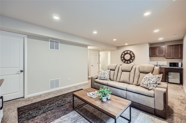 4318 Hessite Loop, Colorado Springs, CO 80938 - living room featuring light colored carpet, bar with sink, beverage cooler, and recessed lighting