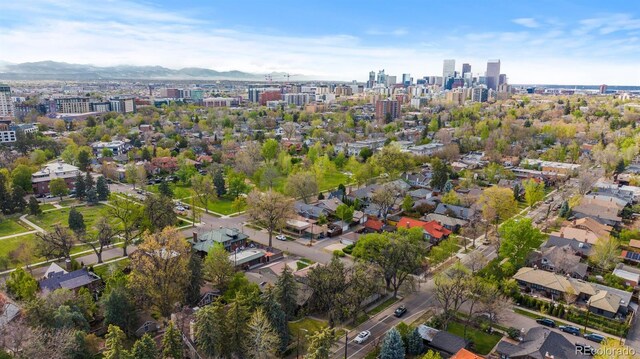 aerial overview of property's location with nearby urban area and a mountain backdrop