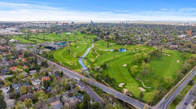 aerial view of property's location featuring a nearby body of water and a local golf course