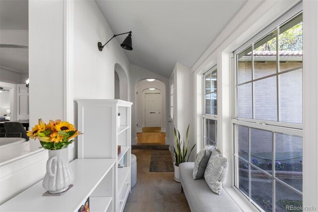 hall with vaulted ceiling and arched walkways