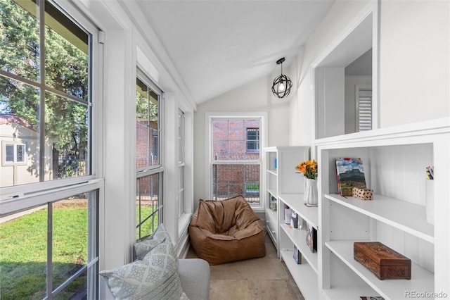 sunroom featuring lofted ceiling